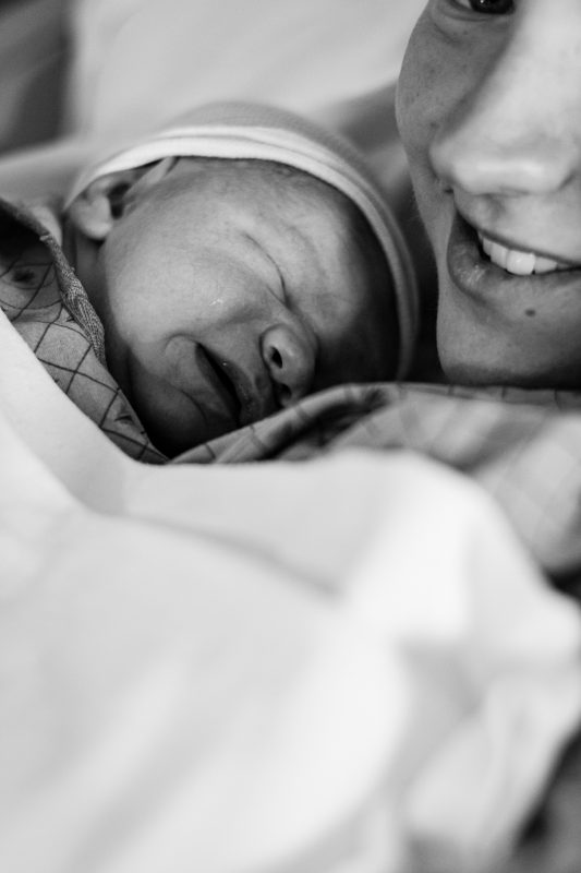 mom holding baby - Huntsville birth photographer