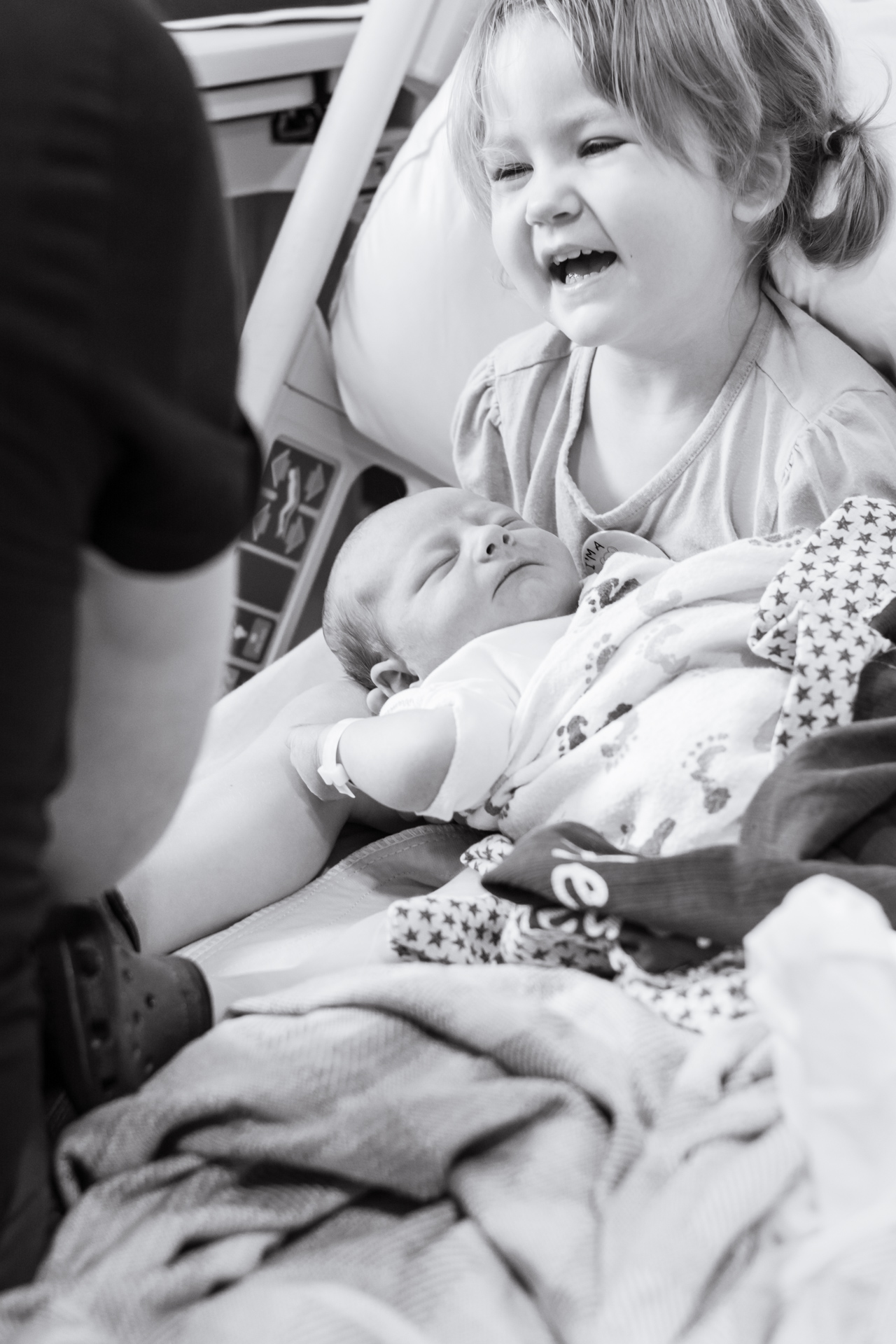 sister holding newborn baby