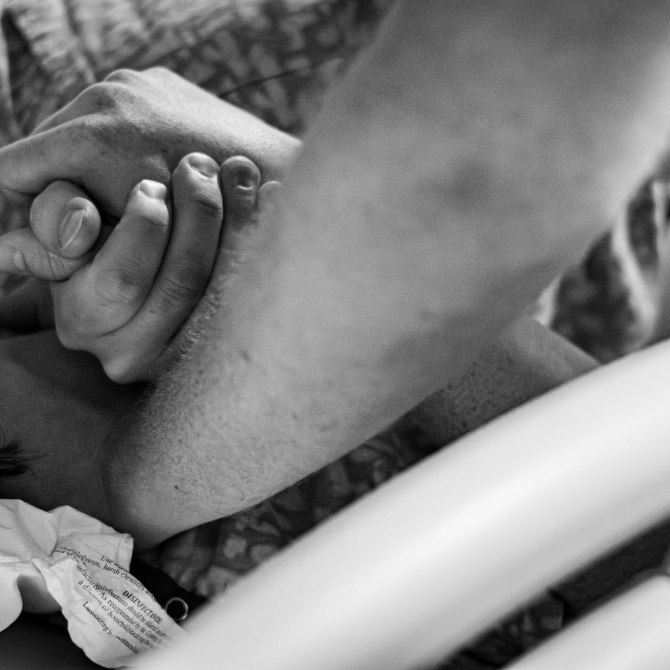 mom and dad holding hands during child's birth
