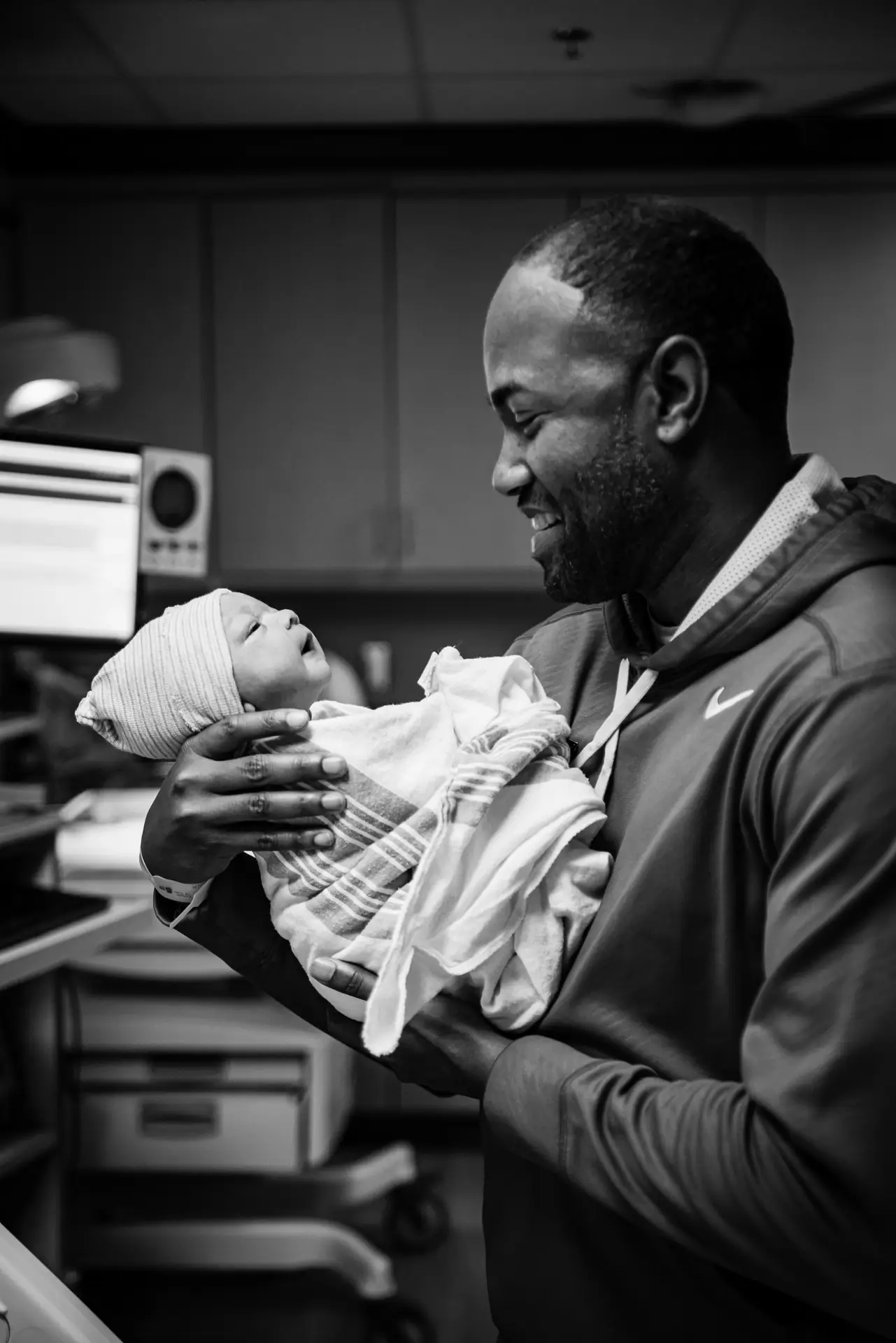 Huntsville birth photography father holding brand new baby