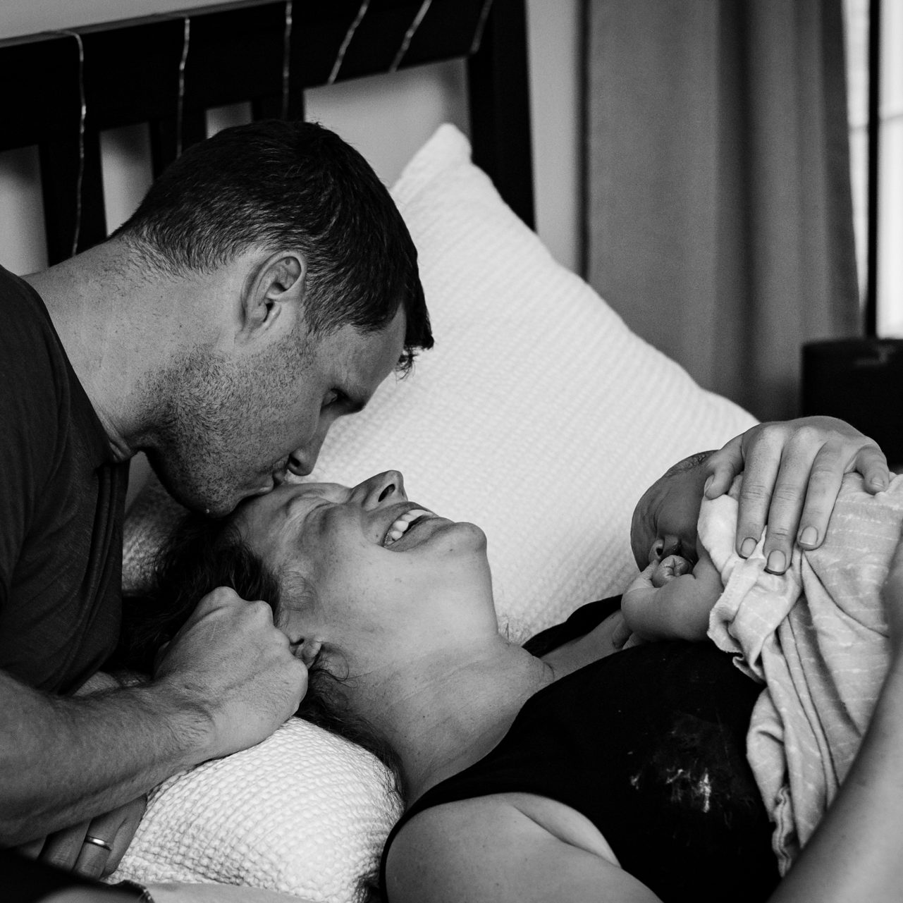 mom and dad with newborn baby